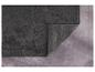 Un tapis de bain gris foncé avec une texture de petites billes