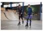 Patins à roulettes, protections et casques dans une rampe de skate.