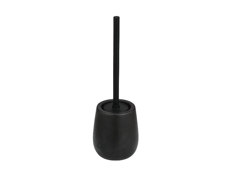 Brosse de toilette noire dans un récipient en céramique.