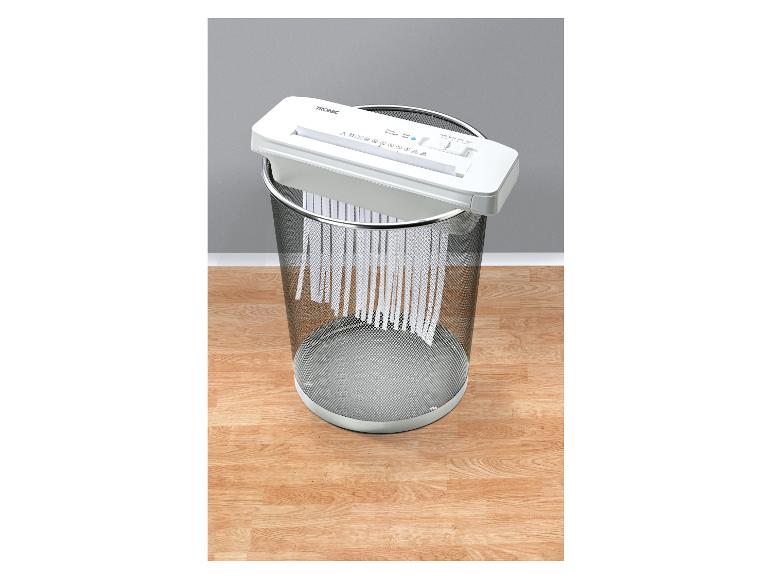 Destructeur de documents TRONIC sur une corbeille en métal, papier déchiqueté tombant.