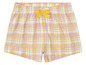 Un pantalon de pyjama à carreaux rose et jaune avec un nœud.