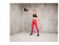 Une femme en tenue de sport tenant un kettlebell.