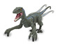 Une figurine de jouet Velociraptor verte avec des pattes mobiles.