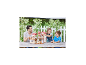 Père et deux enfants jouant avec une grande maison de poupées sur une table en bois à l'extérieur.