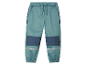 Pantalon de jogging pour enfant, bleu-vert avec des détails bleu marine et réfléchissants.