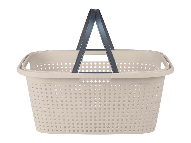 Panier à linge beige perforé avec poignées.