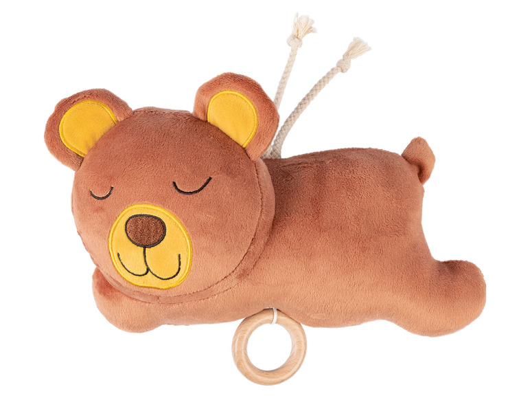 Un ours en peluche brun avec un anneau en bois et des cordons.