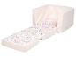 Fauteuil pour enfant rose à motif floral, dépliable en lit.