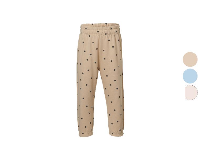 Pantalon de jogging beige à pois noirs, taille élastique et poignets.