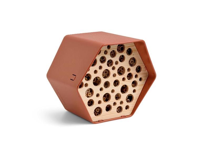 Hôtel à insectes hexagonal couleur terre cuite avec tubes en bois.