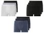 Trois packs de trois boxers en blanc, gris et noir.