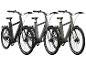 Trois vélos électriques en noir, gris et vert.