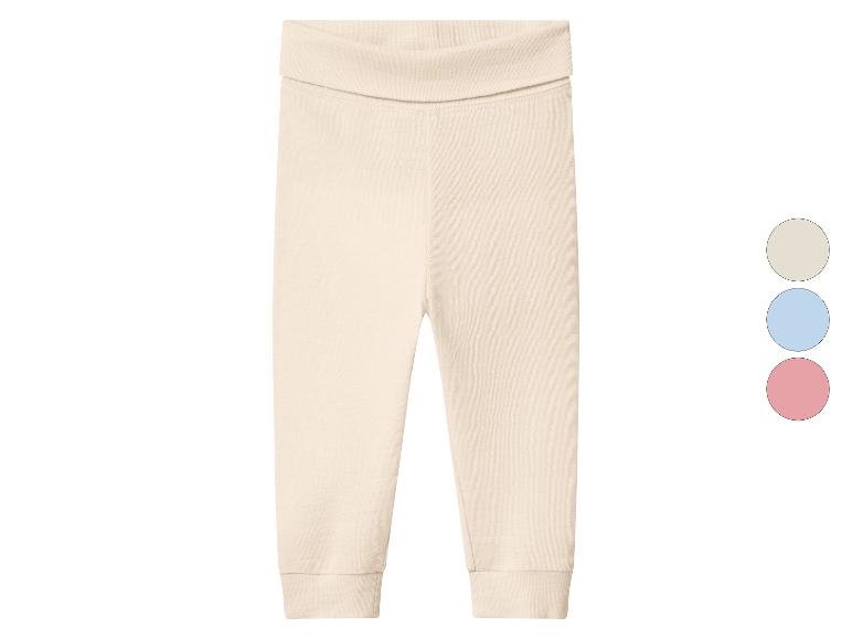 Pantalon bébé beige clair à texture côtelée avec trois échantillons de couleur : beige, bleu et rose.