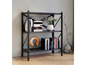 Une étagère en métal noir avec des livres et des décorations.