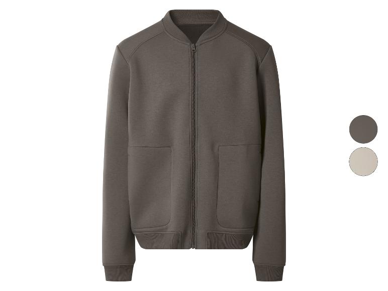 Veste bomber zippée marron foncé avec poches, et un échantillon de couleur beige.
