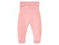 Pantalon de bébé rose avec pieds intégrés et taille élastique.