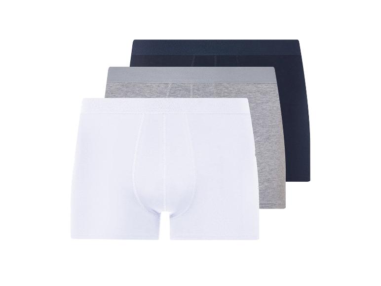 Trois boxers homme : blanc, gris et marine.
