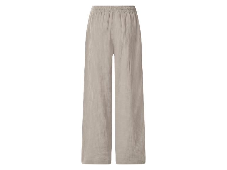 Pantalon large beige clair à taille élastiquée, en tissu froissé.
