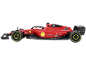 Voiture de course miniature rouge avec jantes jaunes et logos de sponsors.
