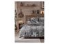 Parure de lit à motif flocon de neige dans une chambre douillette avec mobilier en bois.