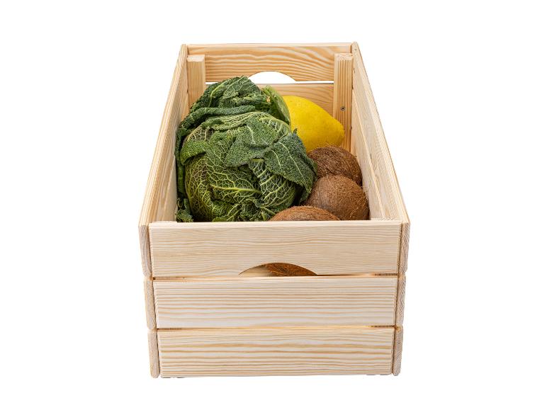 Caisse en bois avec chou, noix de coco et citron.