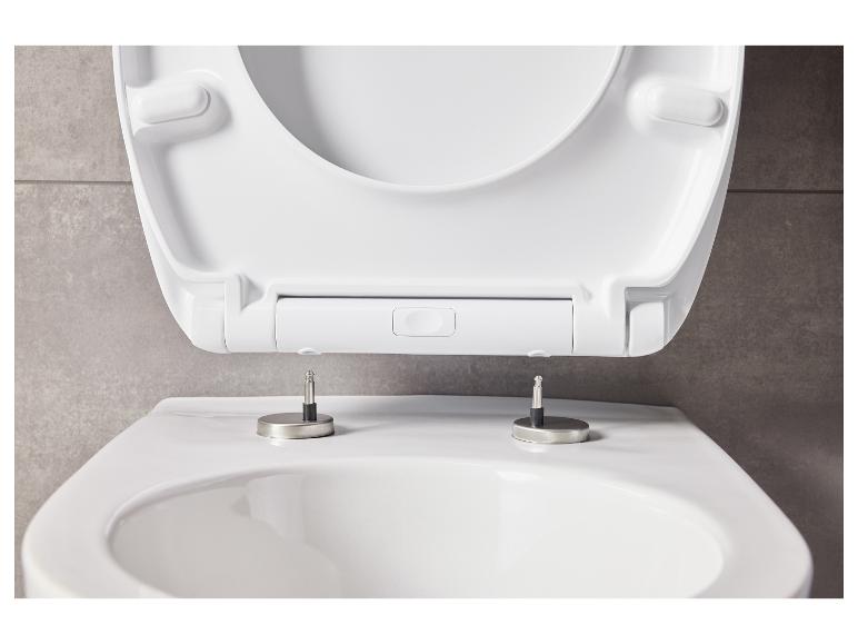 Un abattant de toilettes blanc avec fermeture douce et charnières en acier.