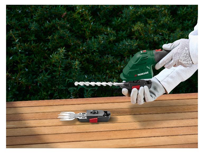 Taille-haie sans fil avec accessoire de fourche sur une table en bois
