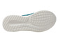Semelle blanche d'une basket bleue.