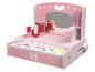 Une coiffeuse en bois rose pour enfants avec miroir, rouges à lèvres et cosmétiques.