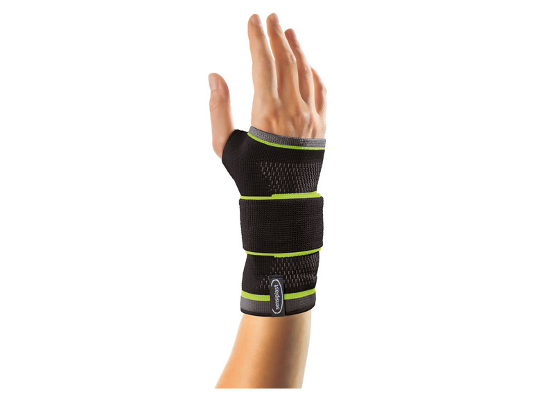 Une attelle de poignet noire avec des accents verts de la marque Bauerfeind.