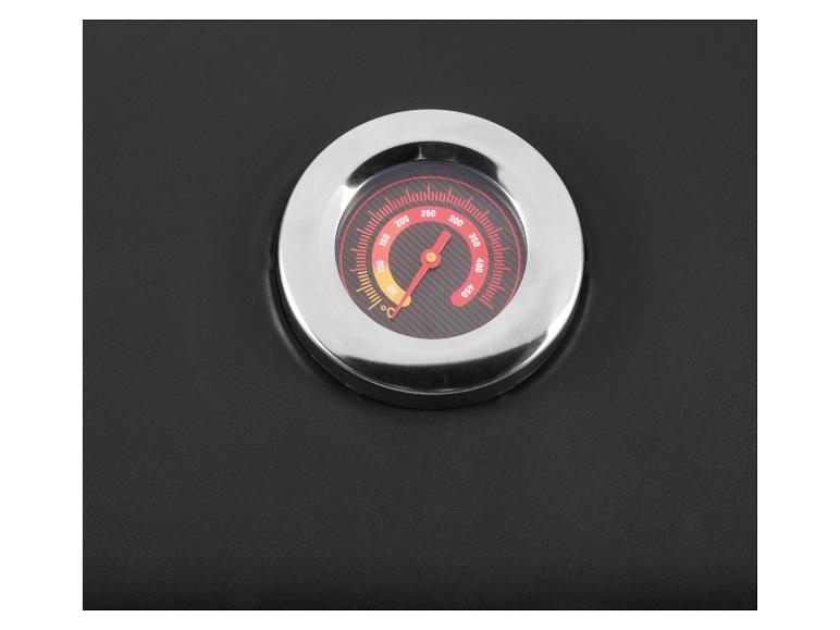 Thermomètre de barbecue intégré avec aiguille rouge indiquant environ 270°C sur un fond noir.