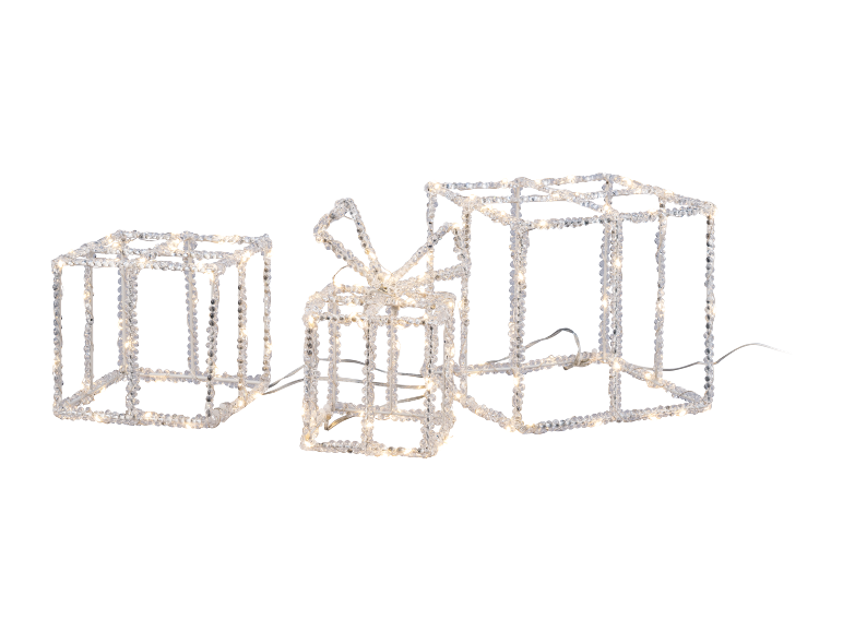 Trois boîtes cadeaux illuminées avec un nœud, faites de matériaux transparents à effet glace.