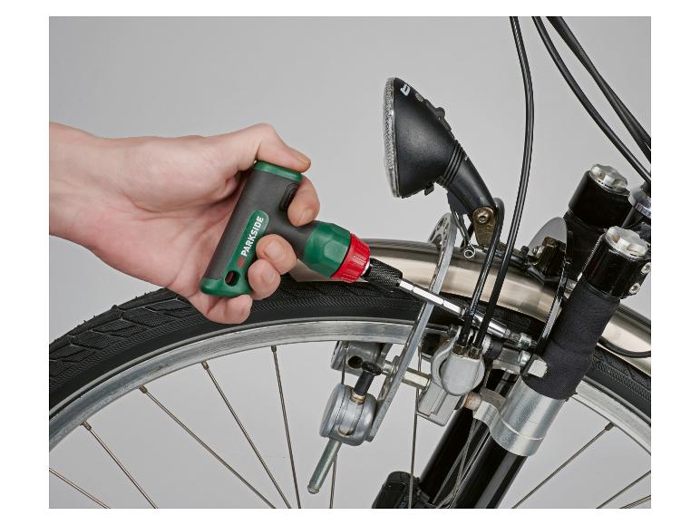Main serrant une vis sur un vélo avec une clé dynamométrique.