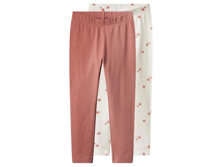 Deux leggings pour filles : un rose et un à fleurs.