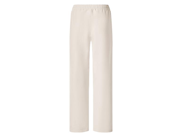 Pantalon large beige clair avec taille élastique.