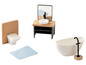 Une baignoire, un lavabo, des toilettes et un tapis de bain pour une maison de poupée.