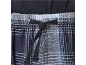 Gros plan d'un bas de pyjama à carreaux avec cordon de serrage noir et taille élastique.