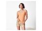 Haut et short de nuit : haut orange et short imprimé feuilles tropicales.