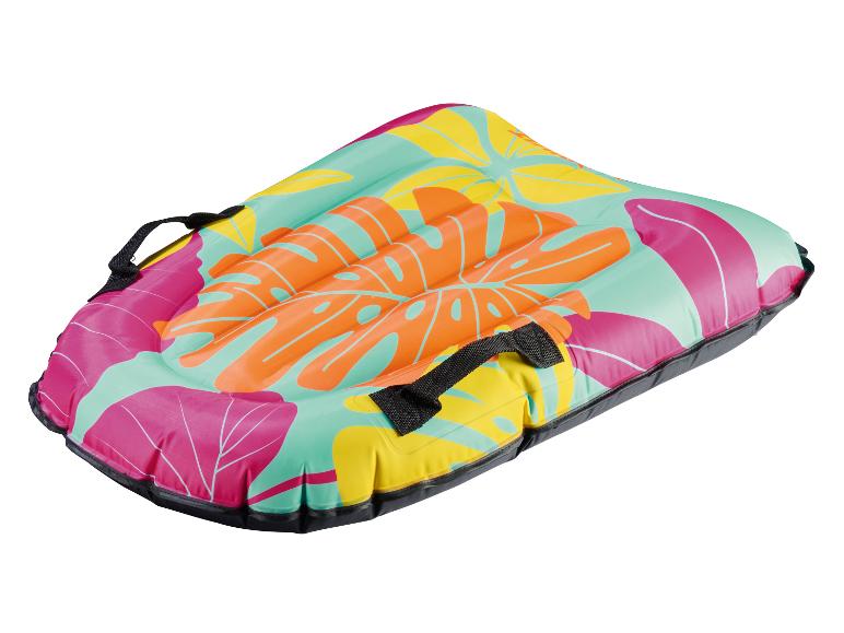 Bodyboard gonflable avec motif de feuilles tropicales roses, oranges, jaunes et sarcelle, avec poignées noires.