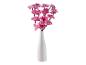 Orchidées artificielles roses dans un vase blanc