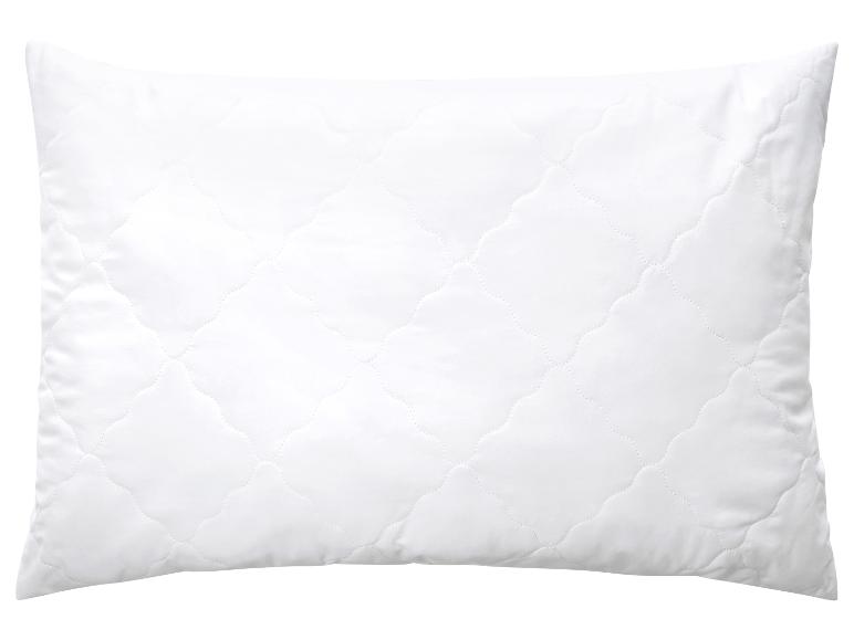 Oreiller blanc matelassé avec motif ondulé