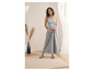 Modèle enceinte portant une robe maxi grise et des sandales Birkenstock.