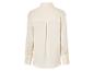 Une chemise en soie crème à manches longues.