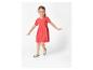 Petite fille portant une robe rouge et des sandales turquoise.