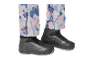 Pantalon de ski rose et bleu à motifs avec des chaussures de ski noires.