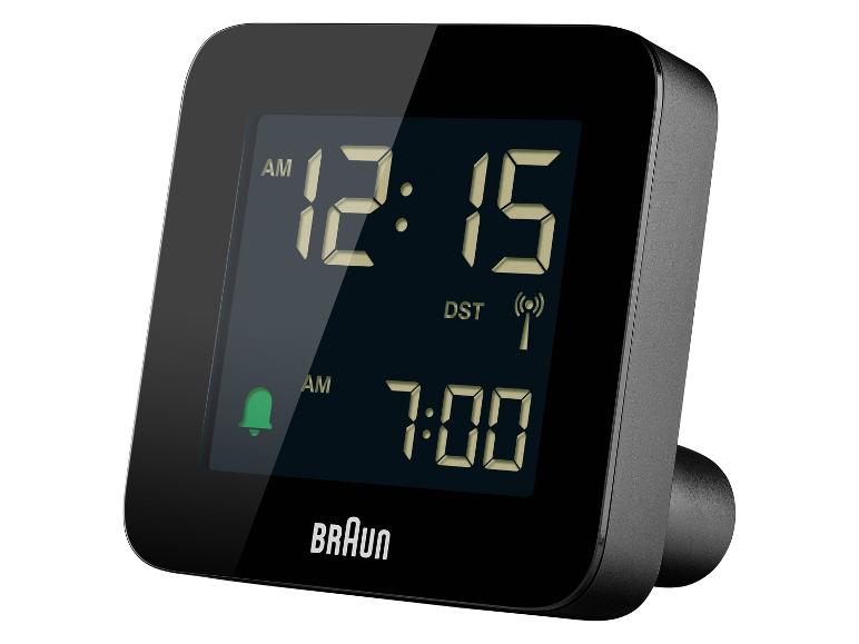 Réveil numérique noir avec affichage de 12h15 et alarme réglée sur 7h00.