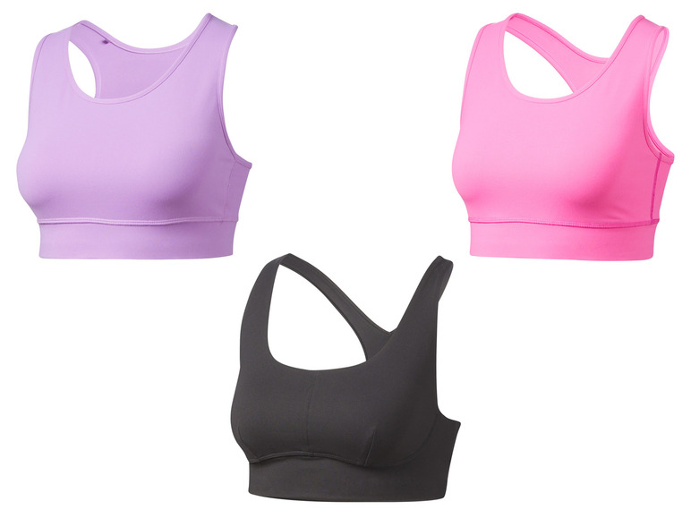 Trois soutiens-gorge de sport en différentes couleurs : violet, rose et noir.