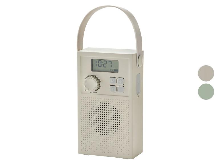 Radio portable avec affichage numérique indiquant 10:27 et poignée, en beige.