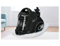 Un aspirateur Bosch noir avec un bac à poussière transparent.