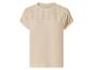 T-shirt beige pour femme à manches courtes avec détails brodés sur les épaules.